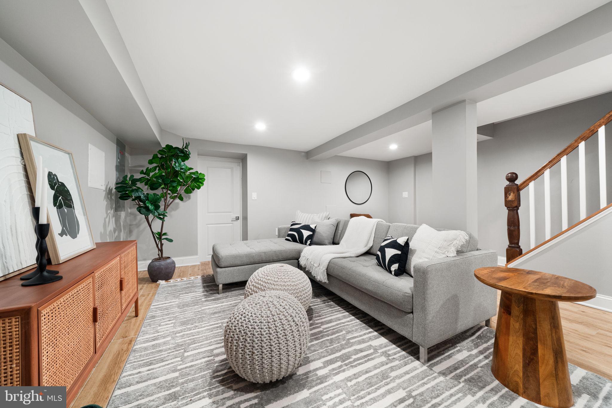 5302 7th Street Northwest Washington, DC 20011 - Photo 31 of 45 a living room with furniture a potted plant and a fireplace