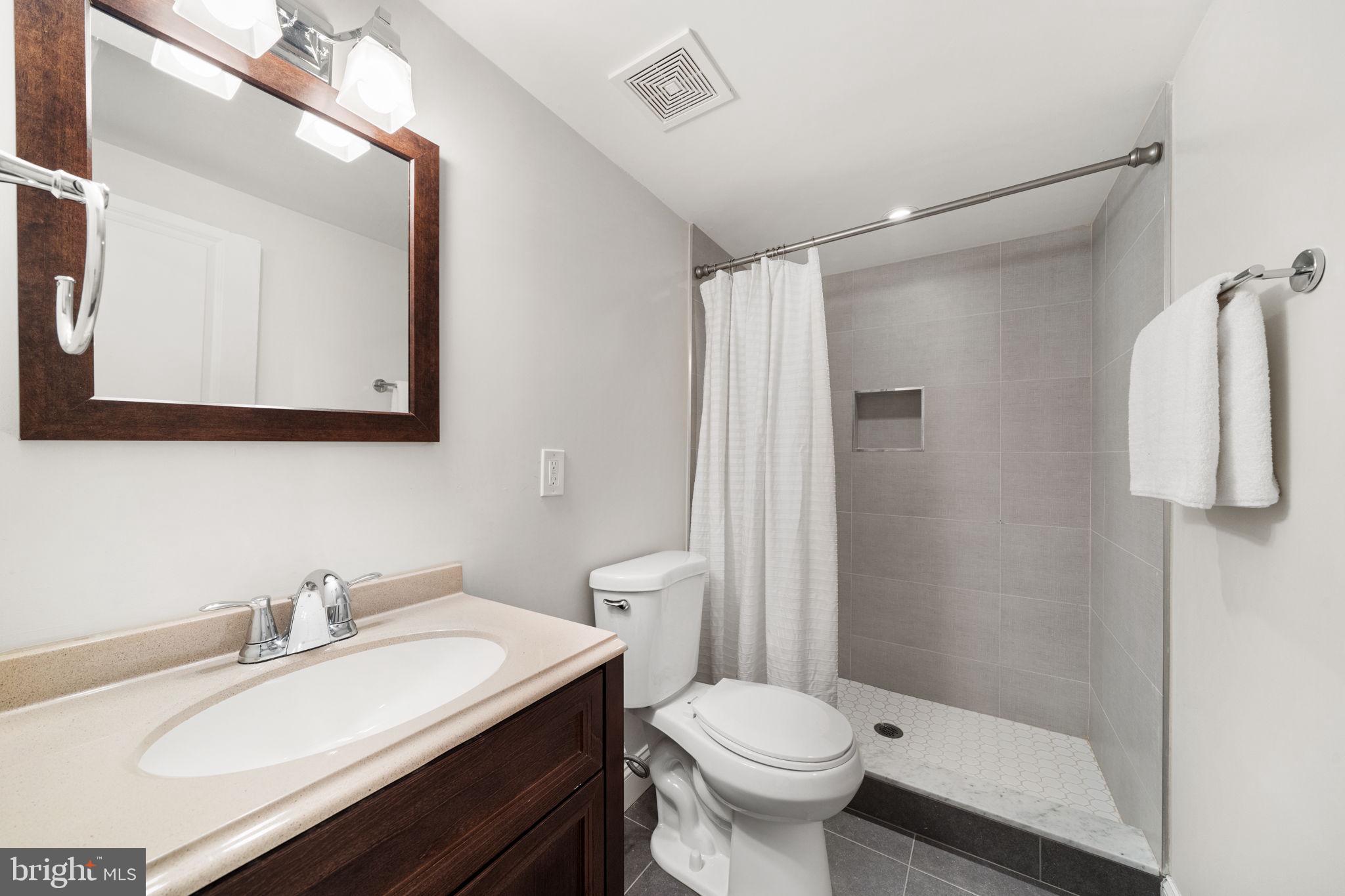 5302 7th Street Northwest Washington, DC 20011 - Photo 34 of 45 a bathroom with a sink toilet and shower