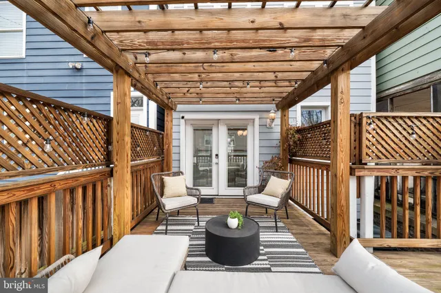 a view of a patio with table and chairs and wooden floor