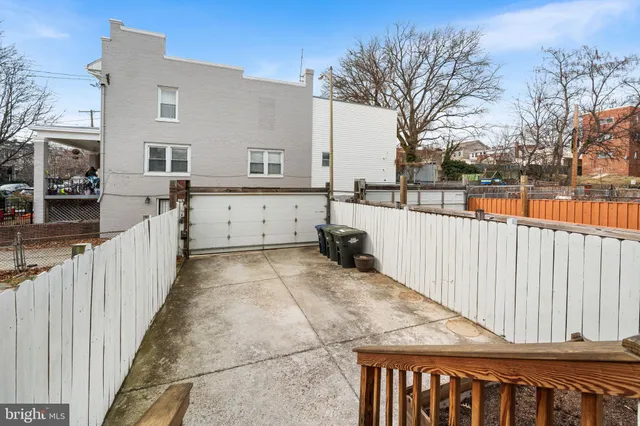a view of a house with a wooden fence