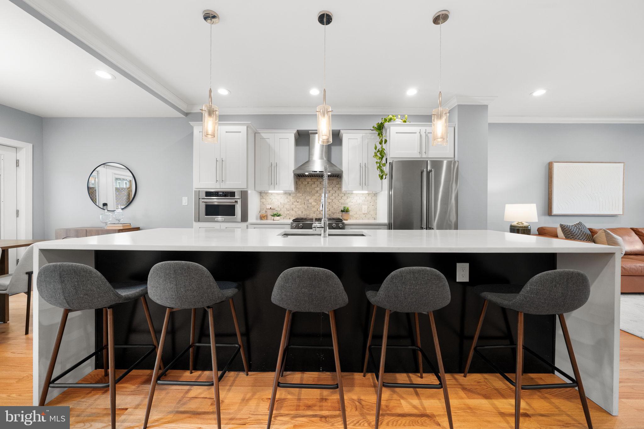 5302 7th Street Northwest Washington, DC 20011 - Photo 9 of 45 a kitchen with granite countertop a dining table chairs cabinets and stainless steel appliances