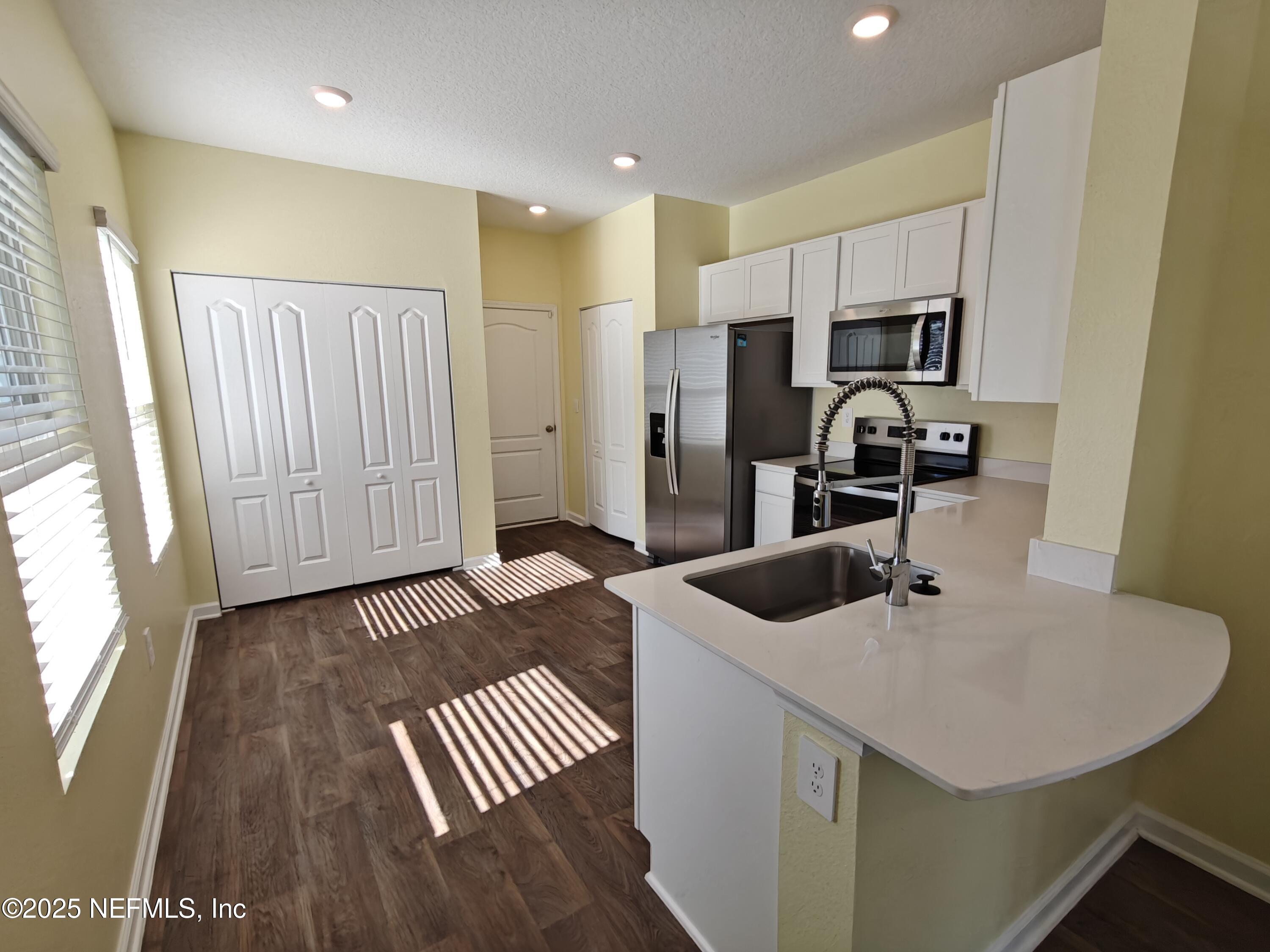 1731 Bridger Trace Middleburg, FL 32068 - Photo 11 of 43 a kitchen with sink and refrigerator