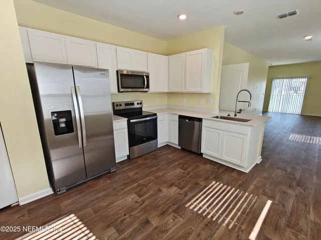 an empty room with a ceiling fan and a window