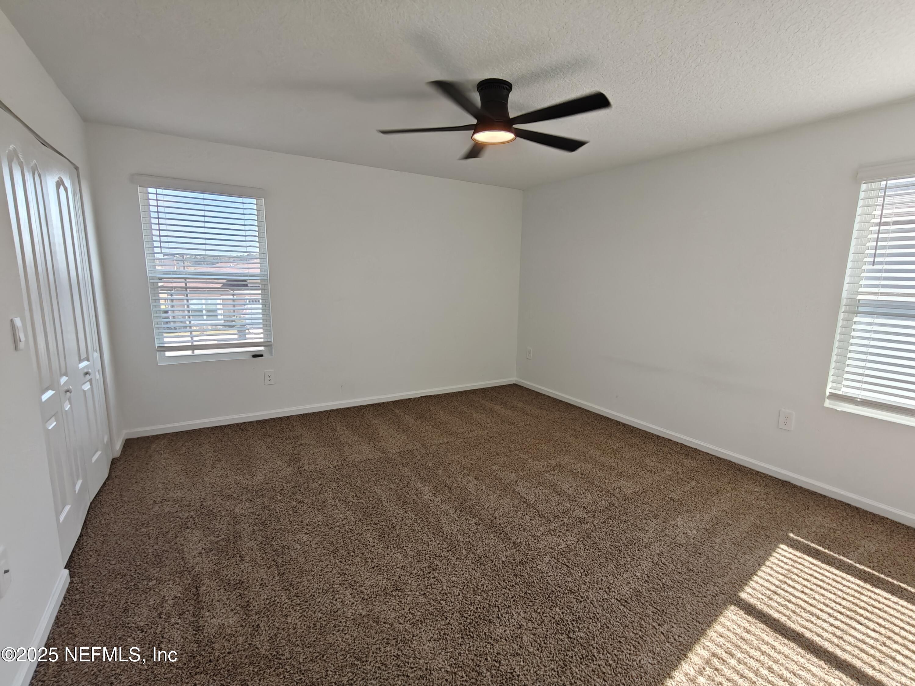 1731 Bridger Trace Middleburg, FL 32068 - Photo 21 of 43 a view of a big room with windows and chandelier fan