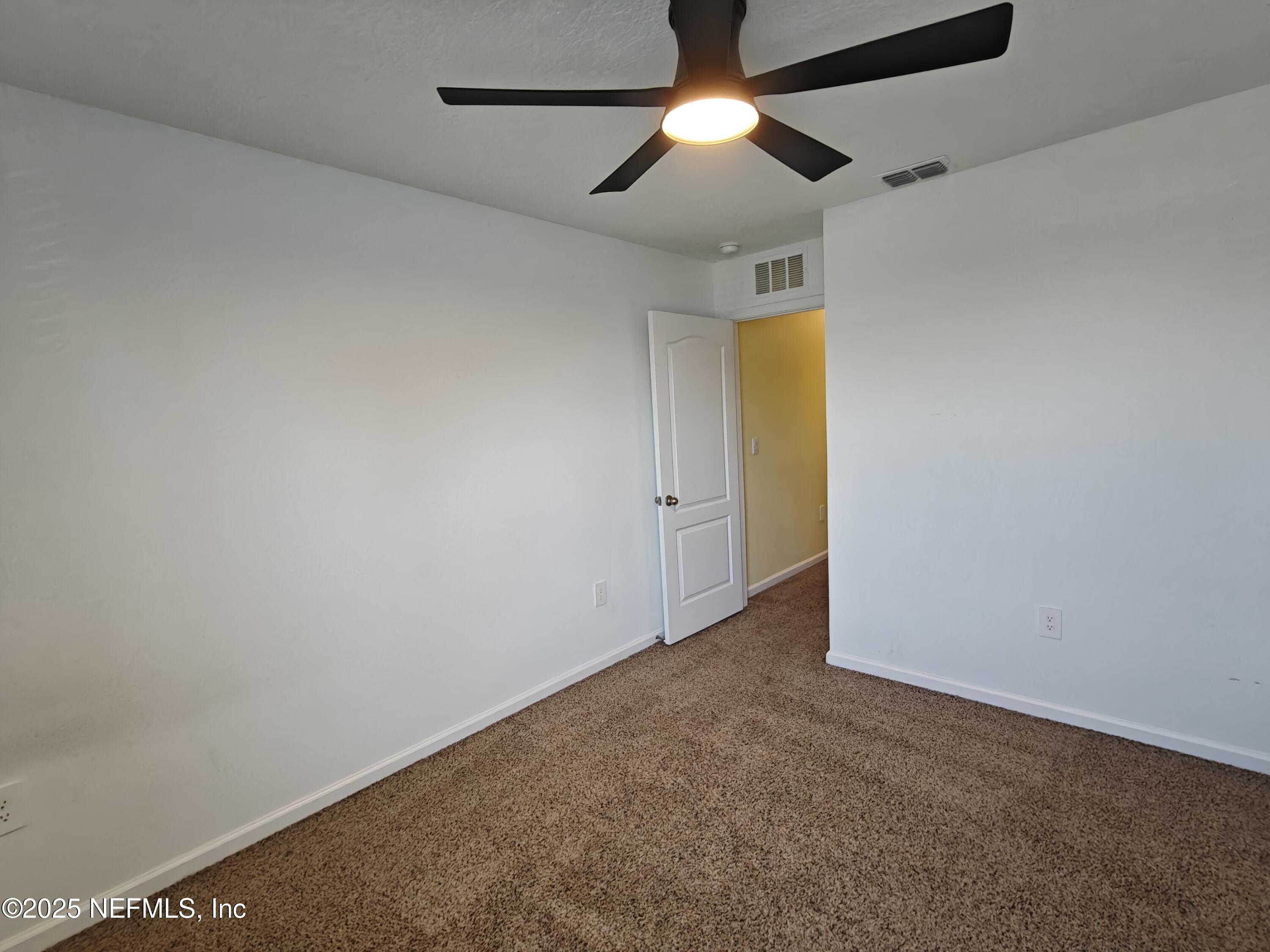 1731 Bridger Trace Middleburg, FL 32068 - Photo 27 of 43 an empty room with a ceiling fan and a window