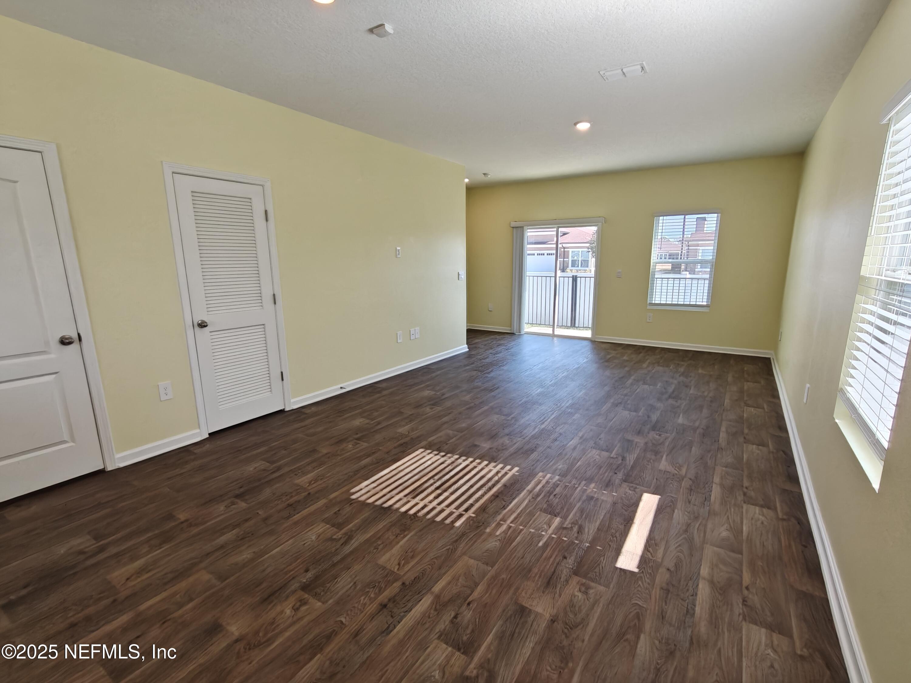 1731 Bridger Trace Middleburg, FL 32068 - Photo 8 of 43 a view of an empty room with wooden floor and a window