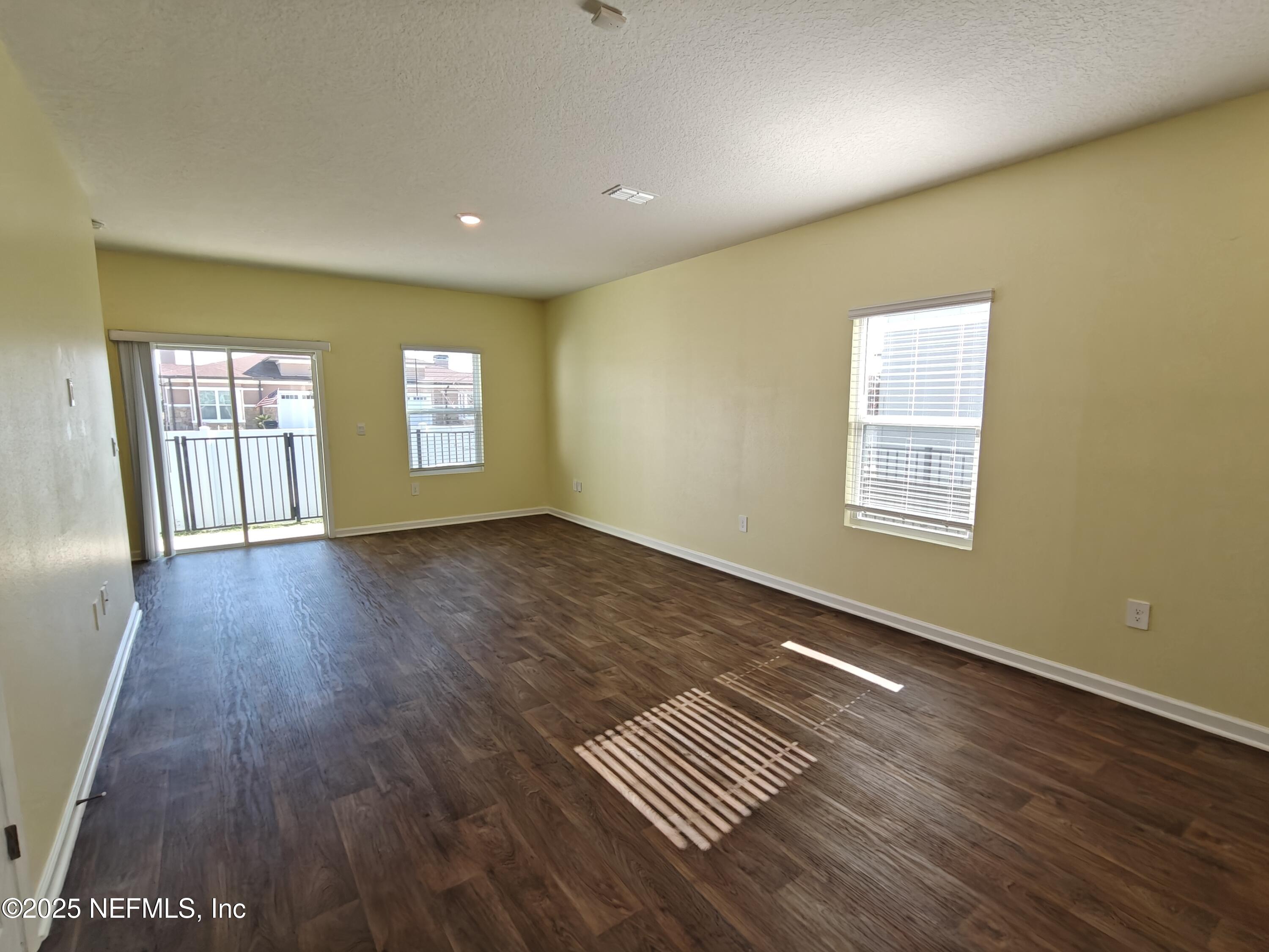 1731 Bridger Trace Middleburg, FL 32068 - Photo 9 of 43 a view of an empty room with wooden floor and a window