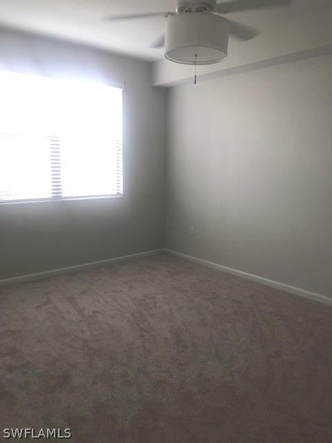 13010 Positano Circle, Unit 101 Naples, FL 34105 - Photo 15 of 26 an empty room with a window