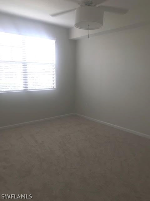 13010 Positano Circle, Unit 101 Naples, FL 34105 - Photo 16 of 26 an empty room with a window