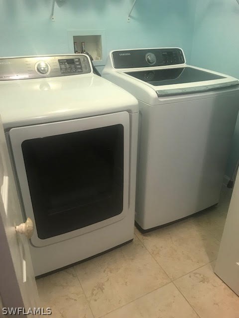 13010 Positano Circle, Unit 101 Naples, FL 34105 - Photo 19 of 26 a utility room with dryer and washer