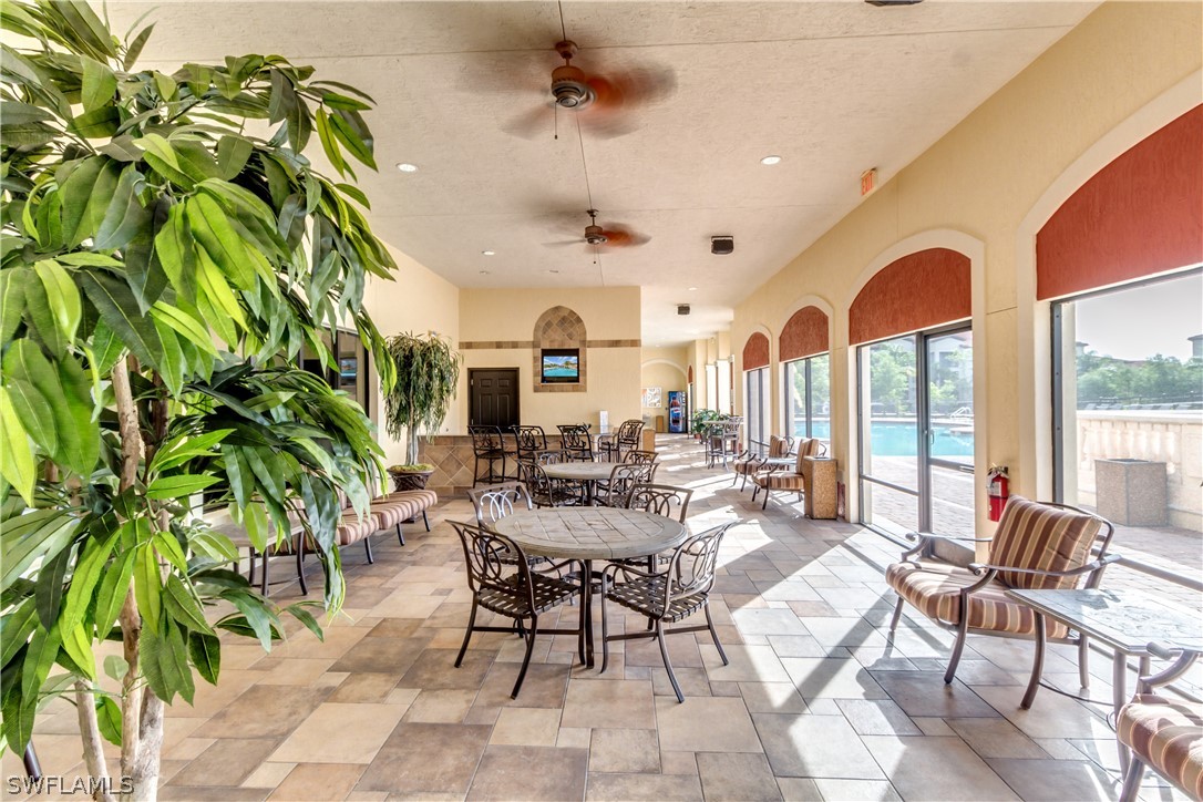 13010 Positano Circle, Unit 101 Naples, FL 34105 - Photo 24 of 26 a view of a livingroom with furniture and a potted plant