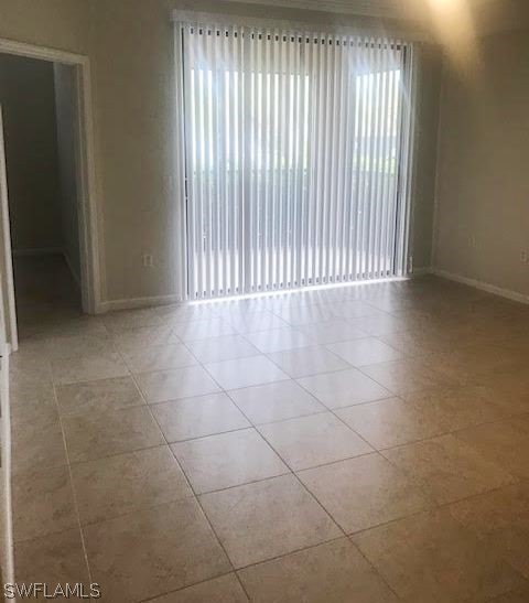 13010 Positano Circle, Unit 101 Naples, FL 34105 - Photo 7 of 26 a view of an empty room with a window