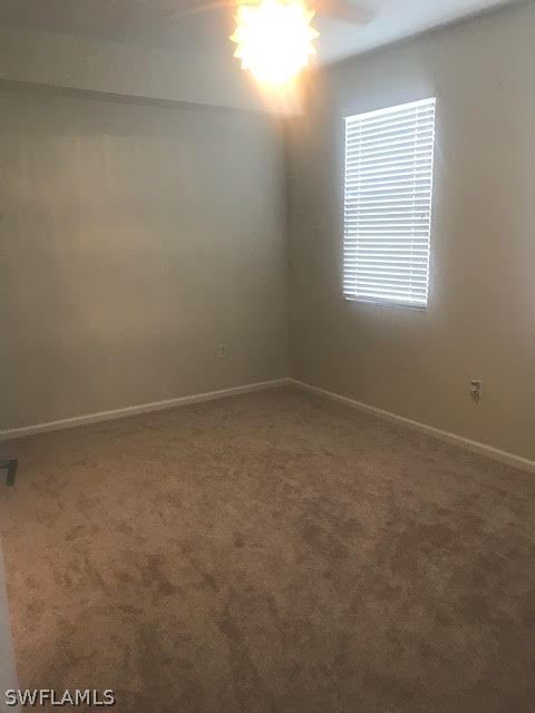 13010 Positano Circle, Unit 101 Naples, FL 34105 - Photo 9 of 26 an empty room with a window