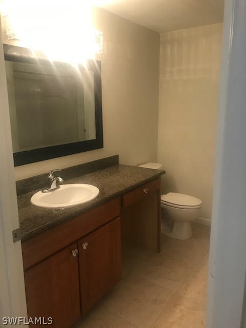13010 Positano Circle, Unit 101 Naples, FL 34105 - Photo 10 of 26 a bathroom with a sink and a toilet