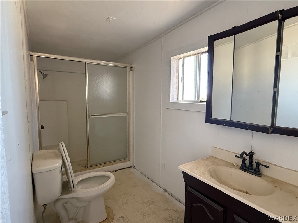 8051 7th Street Dolan Springs, AZ 86441 - Photo 13 of 65 a bathroom with a granite countertop sink toilet a mirror and shower