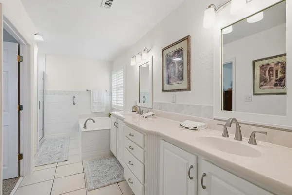 a bathroom with a tub sink and window