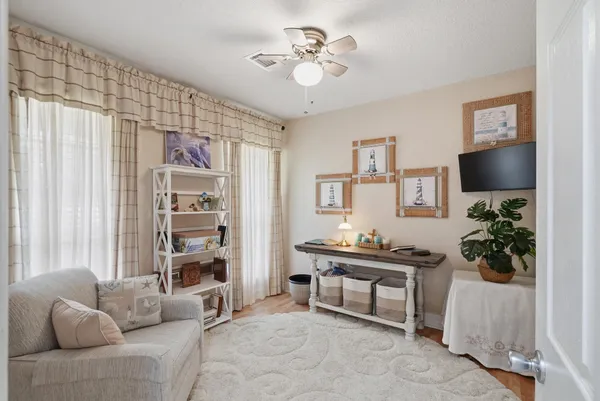 a living room with furniture and a potted plant