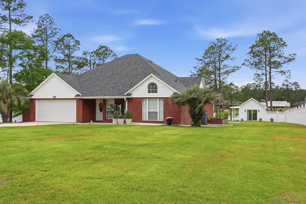 a front view of a house with a yard and garage