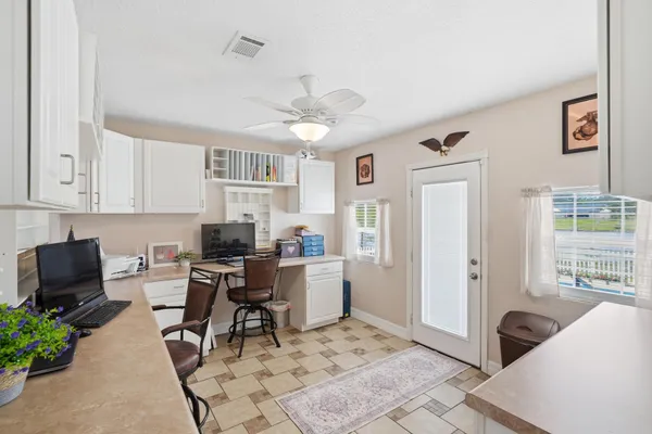 a kitchen with a sink refrigerator and cabinets
