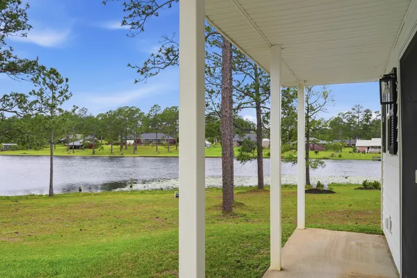 a view of a lake with houses in the background