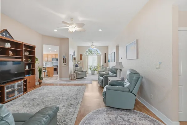 a living room with furniture and wooden floor