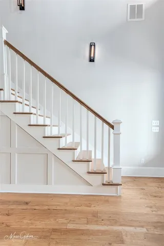 a view of entryway and hall with wooden floor