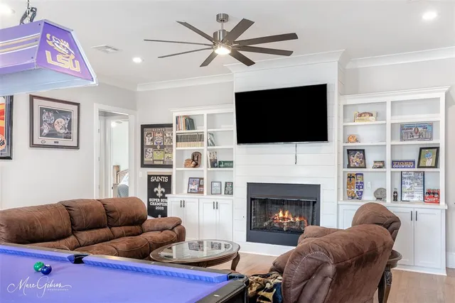 a living room with furniture a flat screen tv and a fireplace