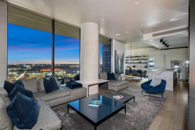 a living room with furniture kitchen view and a table
