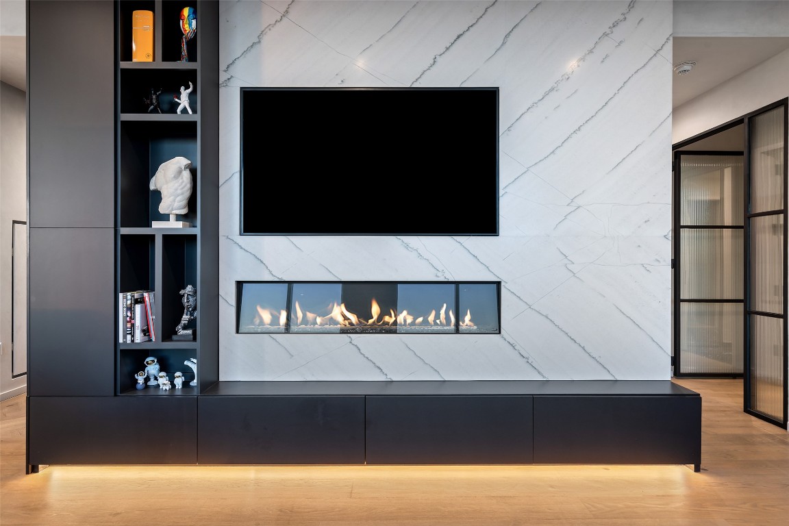 210 Lavaca Street, Unit 2301 Austin, TX 78701 - Photo 12 of 40 a living room with a flat screen tv and a fireplace