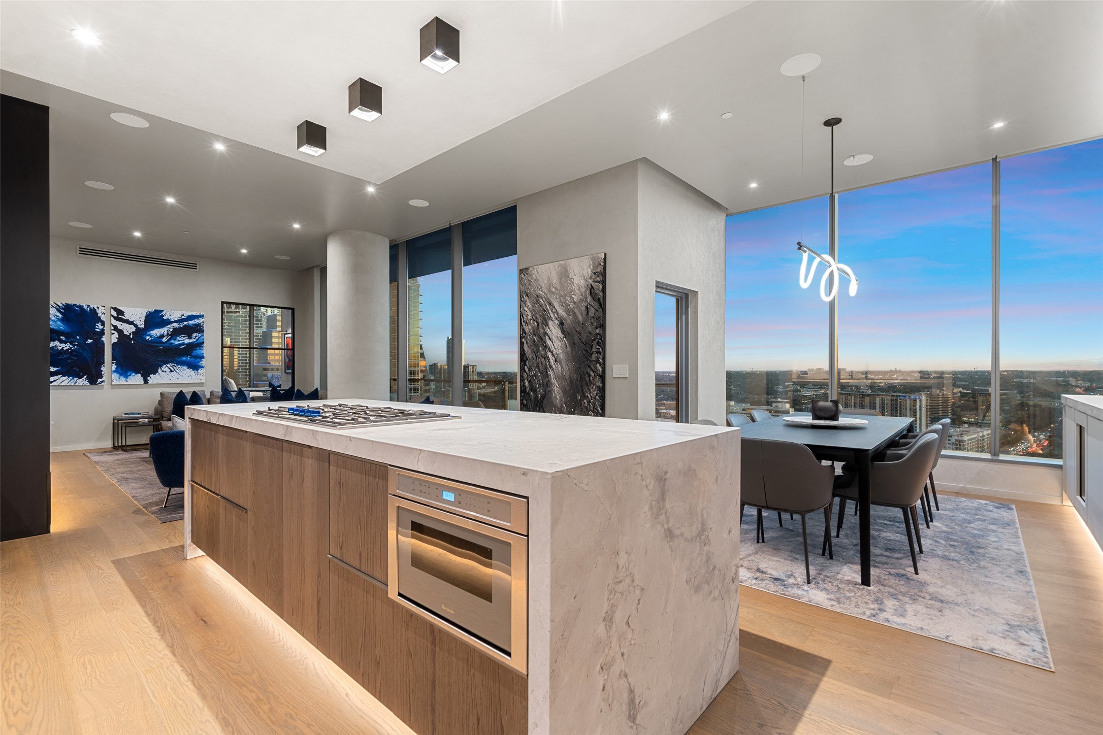210 Lavaca Street, Unit 2301 Austin, TX 78701 - Photo 14 of 40 a kitchen with stainless steel appliances kitchen island a chandelier and a view of living room
