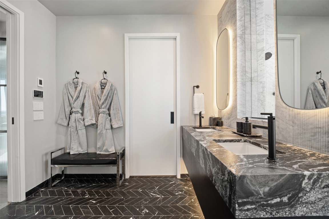 210 Lavaca Street, Unit 2301 Austin, TX 78701 - Photo 26 of 40 a bathroom with a granite countertop sink and a mirror