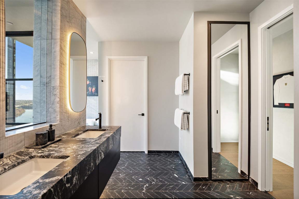 210 Lavaca Street, Unit 2301 Austin, TX 78701 - Photo 27 of 40 a bathroom with a granite countertop sink and a mirror