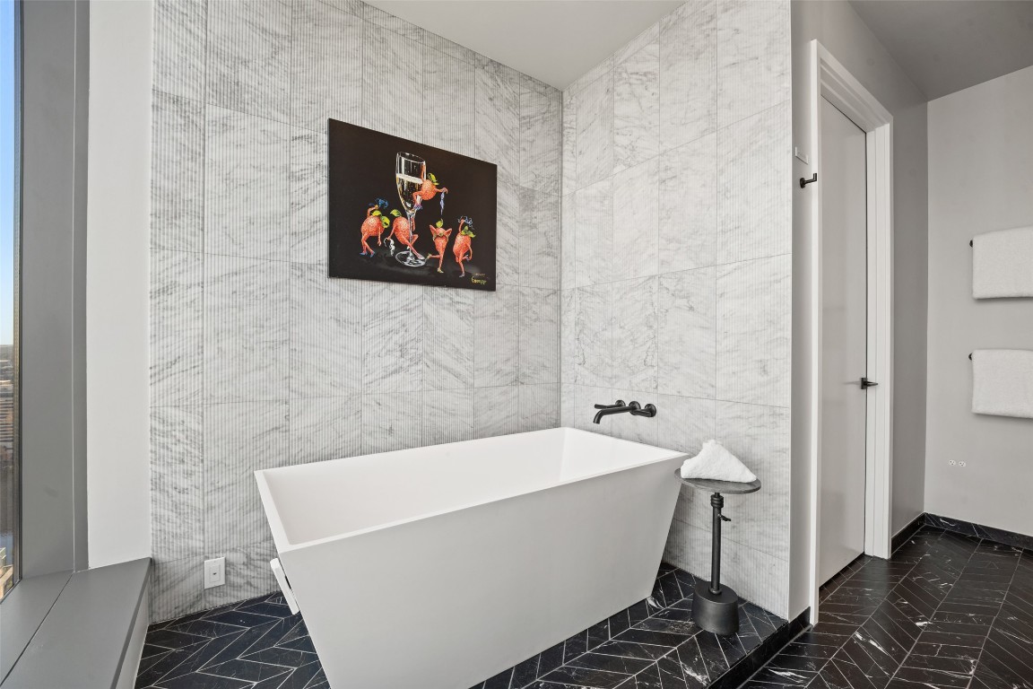 210 Lavaca Street, Unit 2301 Austin, TX 78701 - Photo 29 of 40 a bathroom with a bathtub and shower