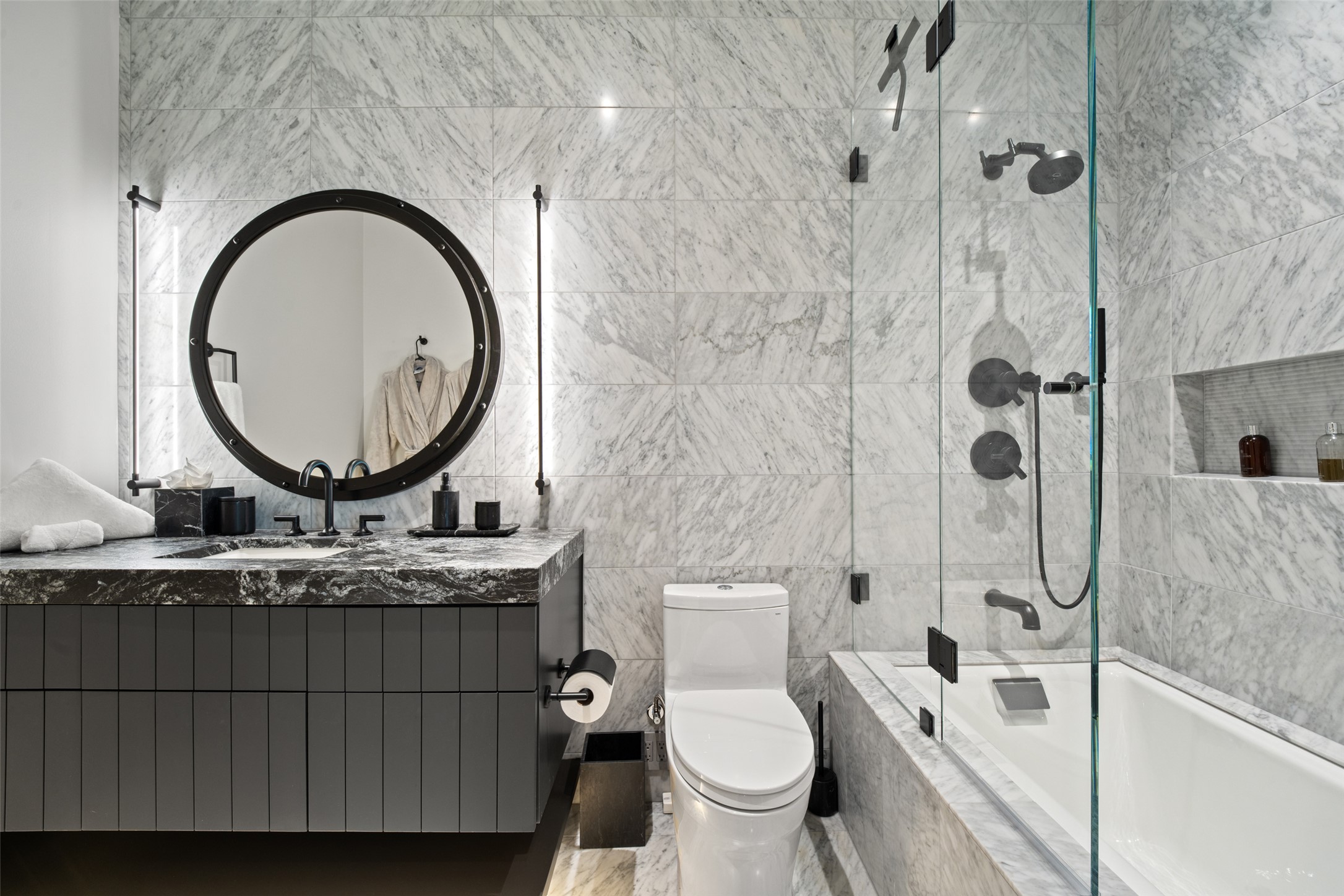 210 Lavaca Street, Unit 2301 Austin, TX 78701 - Photo 33 of 40 a bathroom with a granite countertop toilet a sink and a mirror