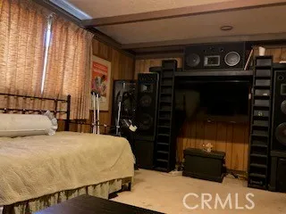 a bedroom with a bed and a mirror