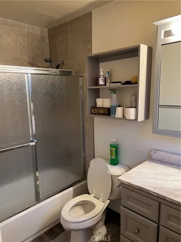 a white toilet sitting next to a bathroom sink