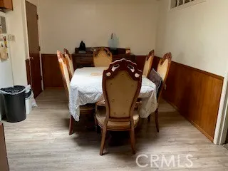a dining room with furniture and wooden floor