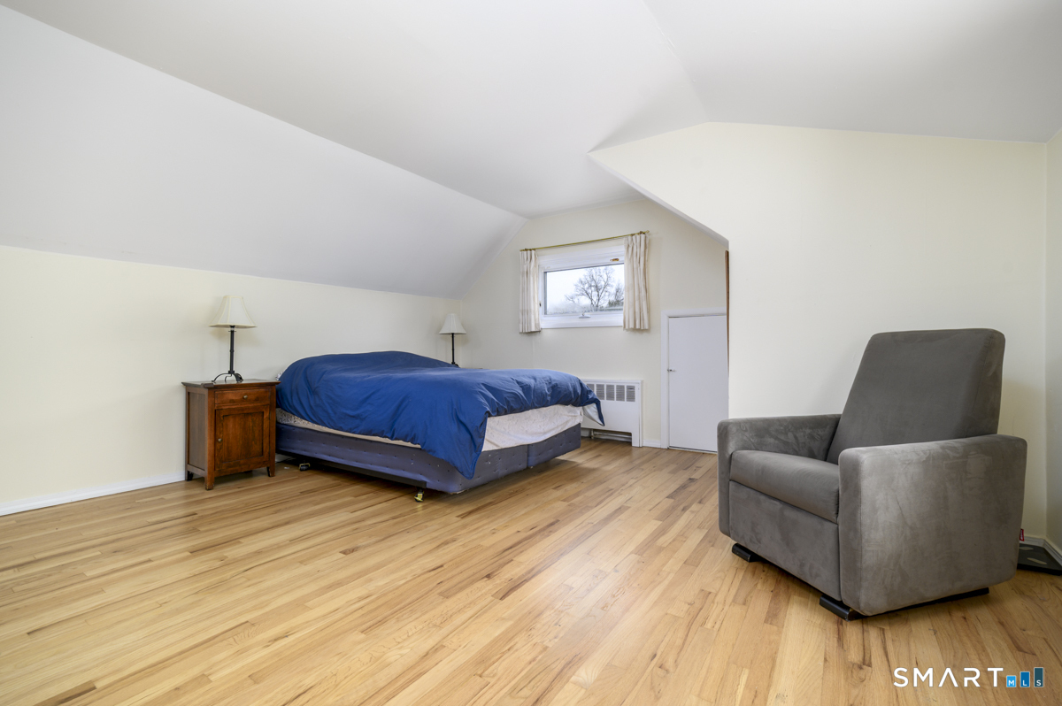 63 Alpine Street Stamford, CT 06905 - Photo 12 of 22 a living room with a couch and a wooden floor