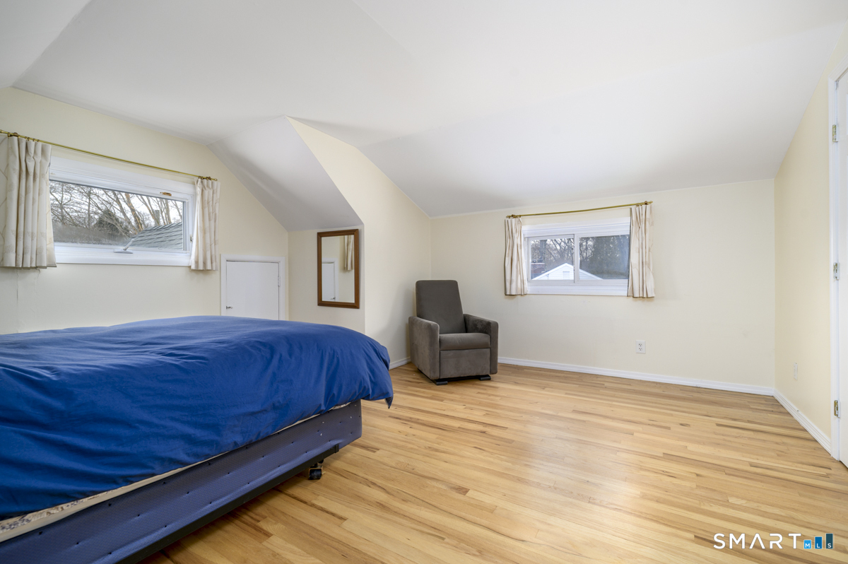 63 Alpine Street Stamford, CT 06905 - Photo 13 of 22 a bedroom with a bed and a painting on the wall