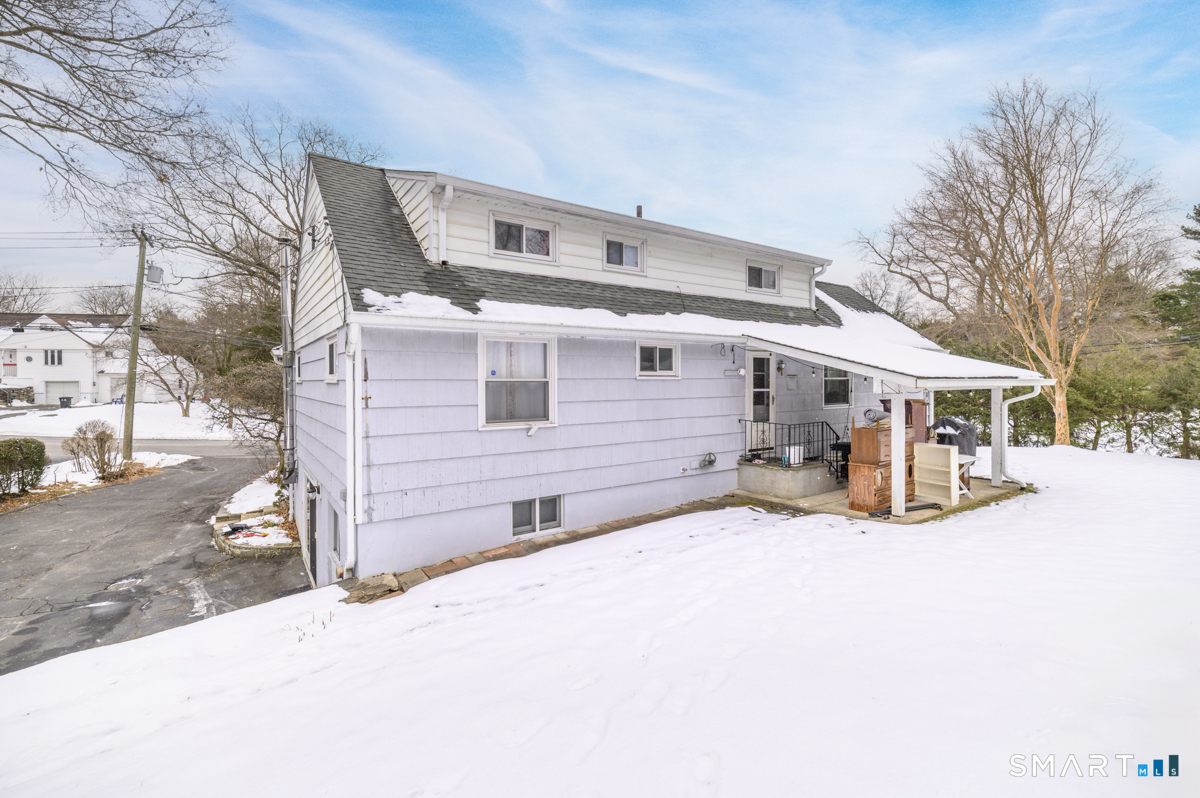 63 Alpine Street Stamford, CT 06905 - Photo 21 of 22 a view of a house with a snow in a yard