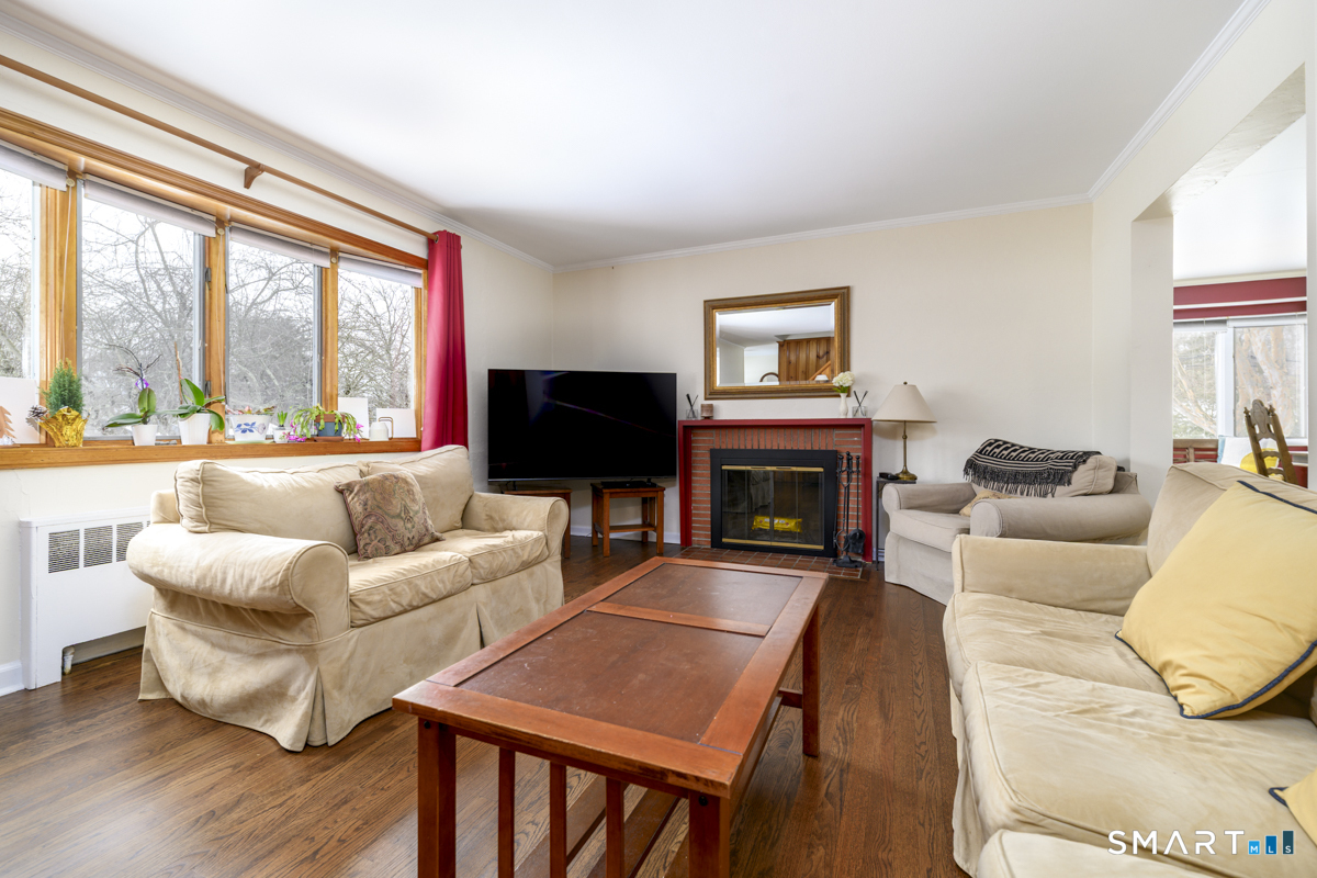 63 Alpine Street Stamford, CT 06905 - Photo 5 of 22 a living room with furniture a large window and a fireplace