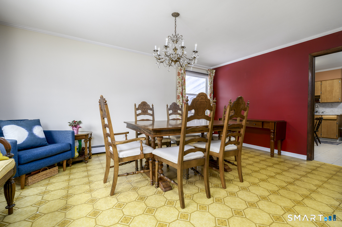 63 Alpine Street Stamford, CT 06905 - Photo 7 of 22 a dining room with furniture and chandelier