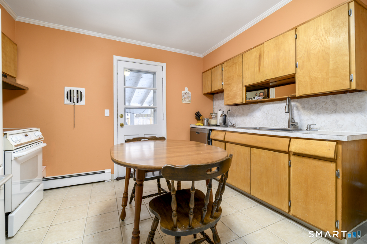 63 Alpine Street Stamford, CT 06905 - Photo 8 of 22 a kitchen with stainless steel appliances granite countertop a sink and a refrigerator