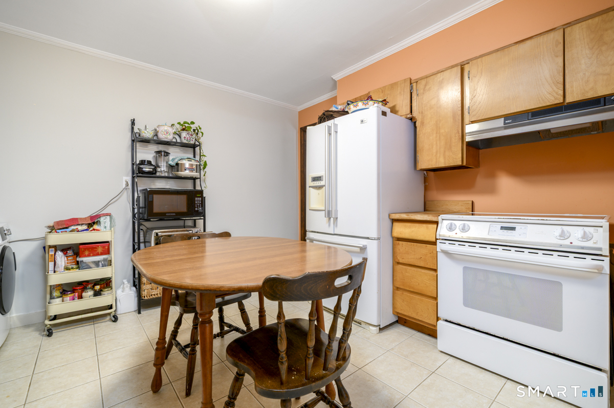 63 Alpine Street Stamford, CT 06905 - Photo 9 of 22 a dining room with a white table and chairs