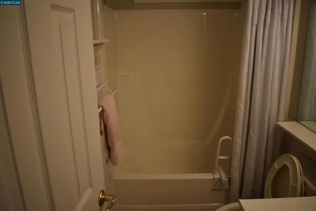 a bathroom with a toilet and a shower
