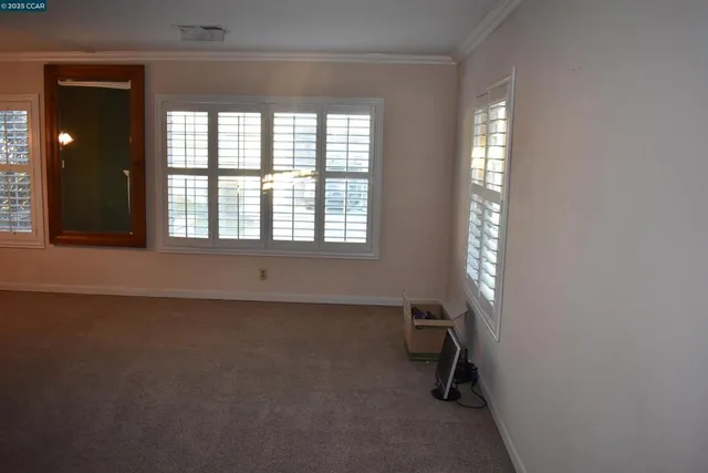 a view of a hallway with a fireplace and a window