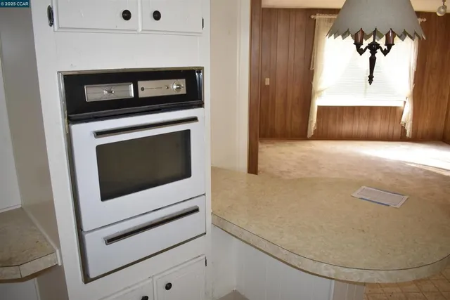 a kitchen with stainless steel appliances granite countertop a refrigerator and a stove