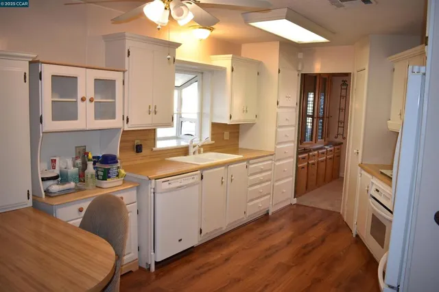 a kitchen with a sink cabinets and refrigerator