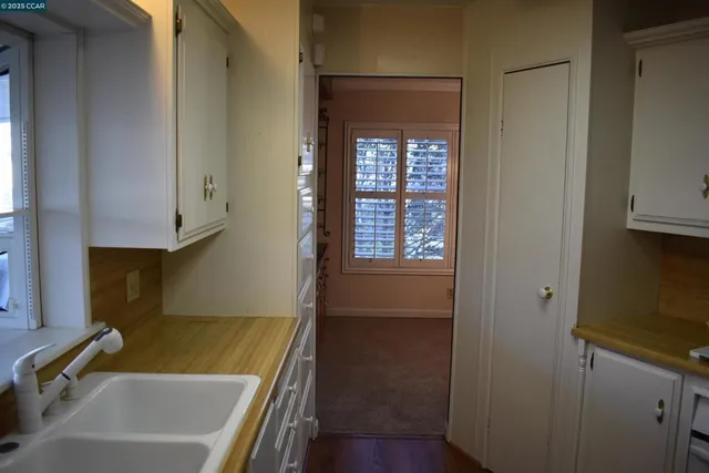 a bathroom with a tub a sink and a window