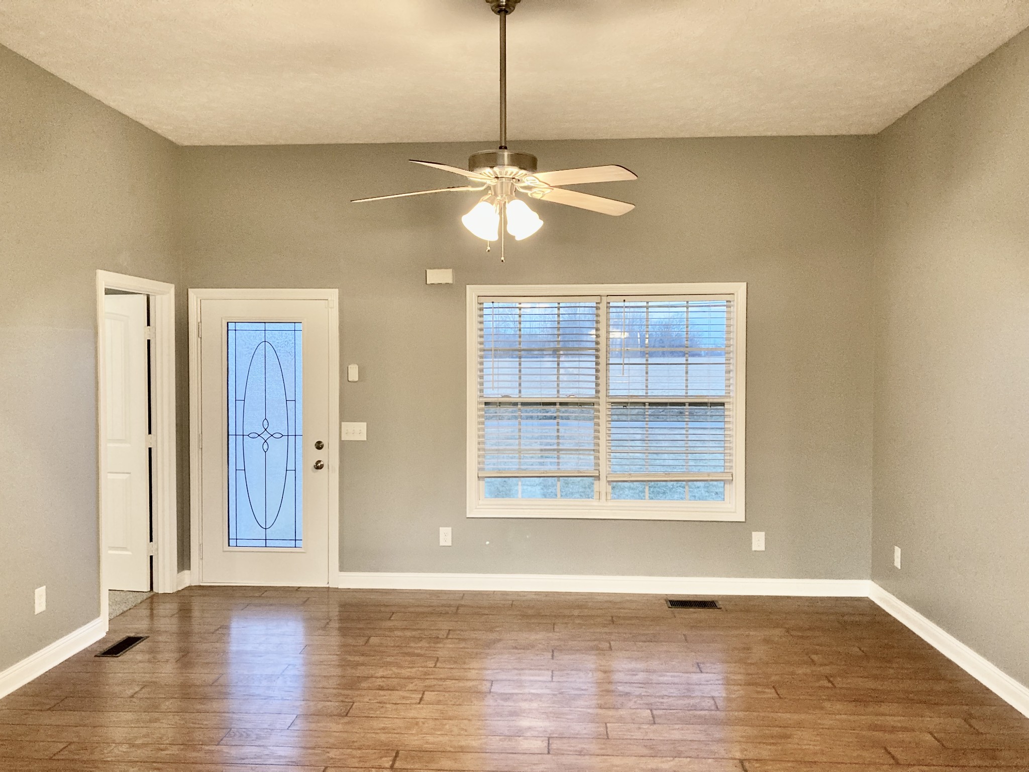 128 T G T Road Portland, TN 37148 - Photo 3 of 8 a view of an empty room with window and wooden floor